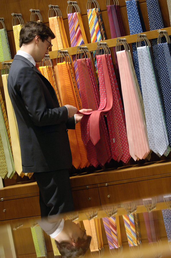 A customer shops for ties in a Hermes shop on via Sant&#039;Andrea in Milan, Italy.