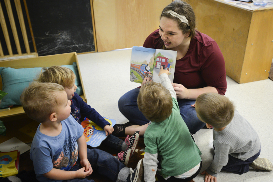 Mariah Laidlaw reads to toddlers Thursday morning at the Central Park Child Care Center in Vancouver. The Central Park center is one of 29 centers making up the Clark County Child Care Consortium.