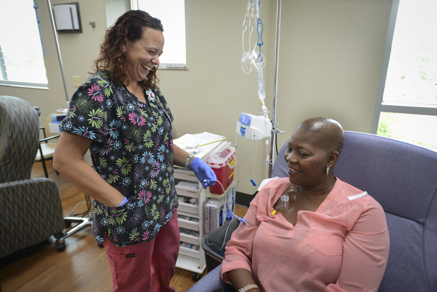 Registered nurse Kathryn Vandberg prepares Jenneh Onwumere, 41, of Woodland for her final chemotherapy treatment Sept. 15 at The Vancouver Clinic. Onwumere was diagnosed with breast cancer in May and will undergo a double mastectomy Tuesday.