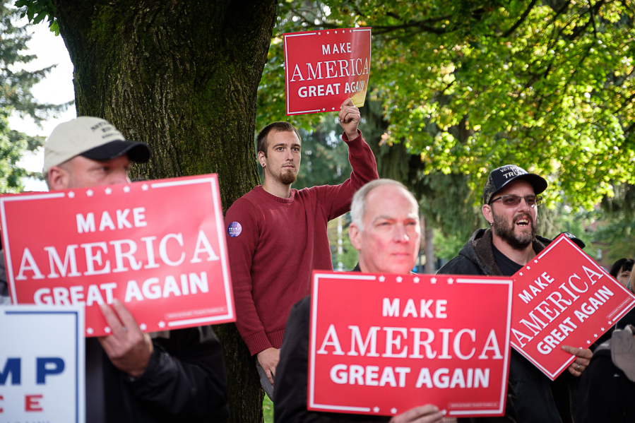 Donald Trump supporters hold signs at the Trump for president rally at Esther Short Park on Sunday.