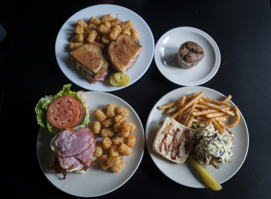 The Informant, clockwise from top left, is served Oct. 24 alongside a zucchini muffin, the Slaw Shank sandwich and the Book and Release burger at The Hoosegow Smoke House BBQ in downtown Vancouver.