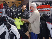Parts manager Asadour (Ozz) Demirjian, left, chats with Parts Unlimited sales representative Dave York at Pro Caliber Motorsports in Vancouver.