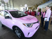 Don Stose, the legislative liaison for the Pink Lemonade Project, right, and Jeanne Firstenburg, former president of the Pink Lemonade Project, admire a pink Toyota RAV4 on Friday at McCord&#039;s Vancouver Toyota. McCord&#039;s donated the SUV to the Vancouver nonprofit. Markon Brand Design wrapped the vehicle in pink and the nonprofit&#039;s logos.