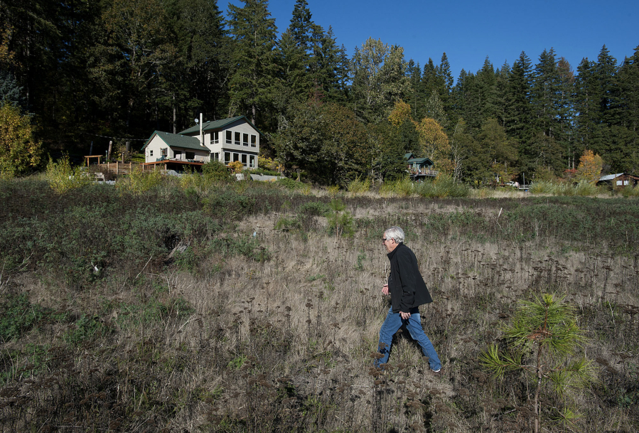 Al Greenwood walks through what used to be the bottom of Northwestern Lake along the White Salmon River. Five years after the breach, cabin owners are still adjusting to life without the lake.