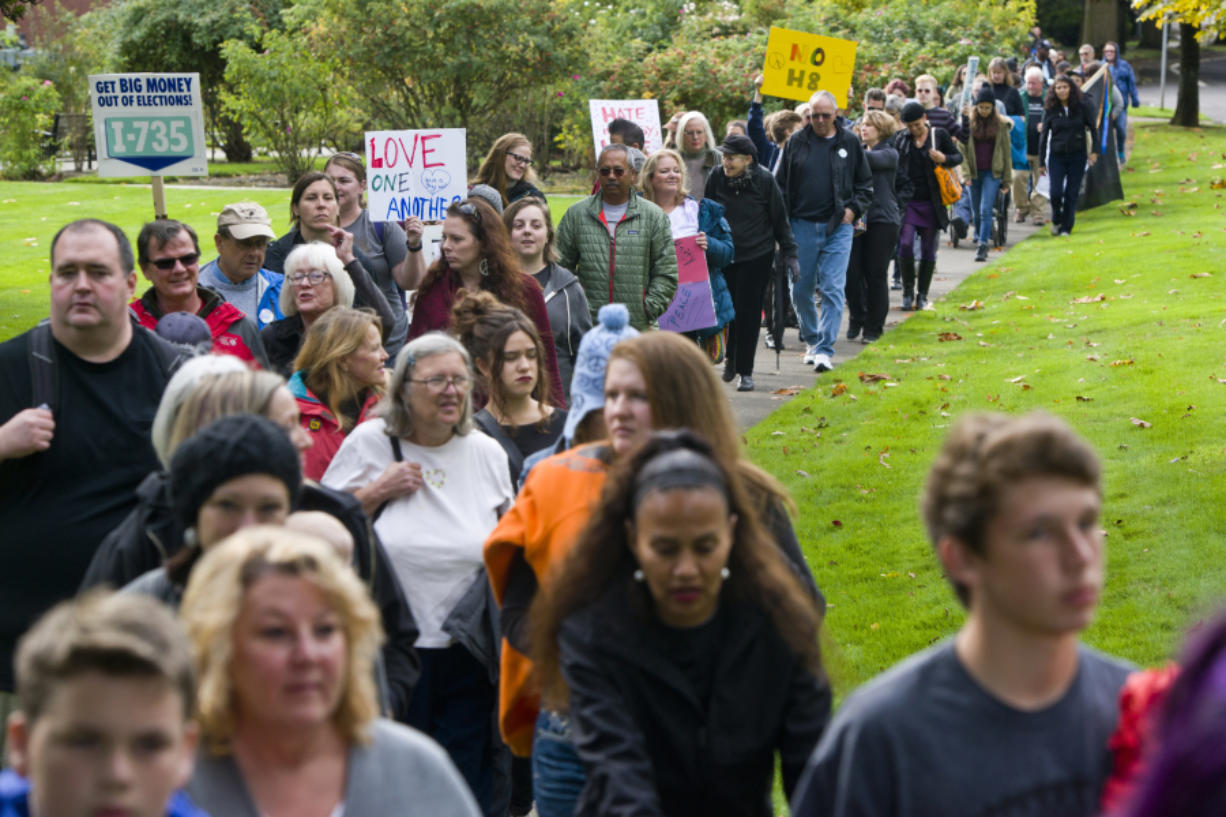 A line of people walk in a unity march Sunday afternoon along Evergreen Boulevard in Vancouver. Nearly 150 people participated in the event.
