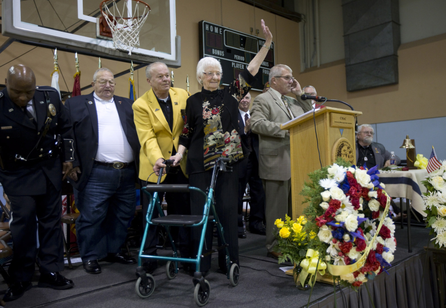 Waving to the crowd, Rae Cheney, 96, acknowledges the applause after describing how the death of her son Lt. Dan Cheney in Vietnam led to a family legacy of &quot;turning sorrow into service.&quot; They started an outreach program, PeaceTrees Vietnam.