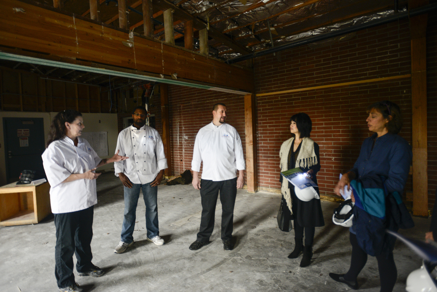 Clark College Cuisine Instructor Aaron Guerra, center, talks Thursday to interested wine and beer distributors about Clark College&#039;s new culinary program during a tour of the facility that&#039;s under construction, aiming to open next fall.