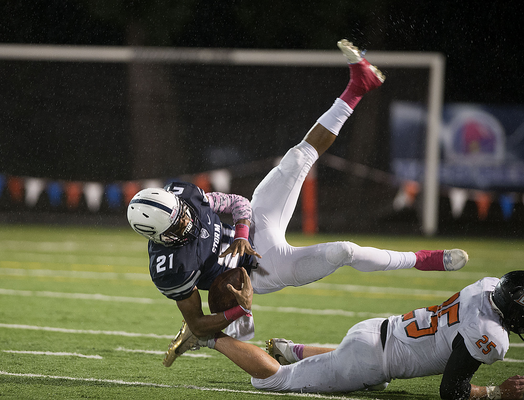 Skyview's Jeremiah Wright (21) is taken down by Battle Ground's Max Randle (25) at Kiggins Bowl on Thursday night, Oct. 13, 2016.