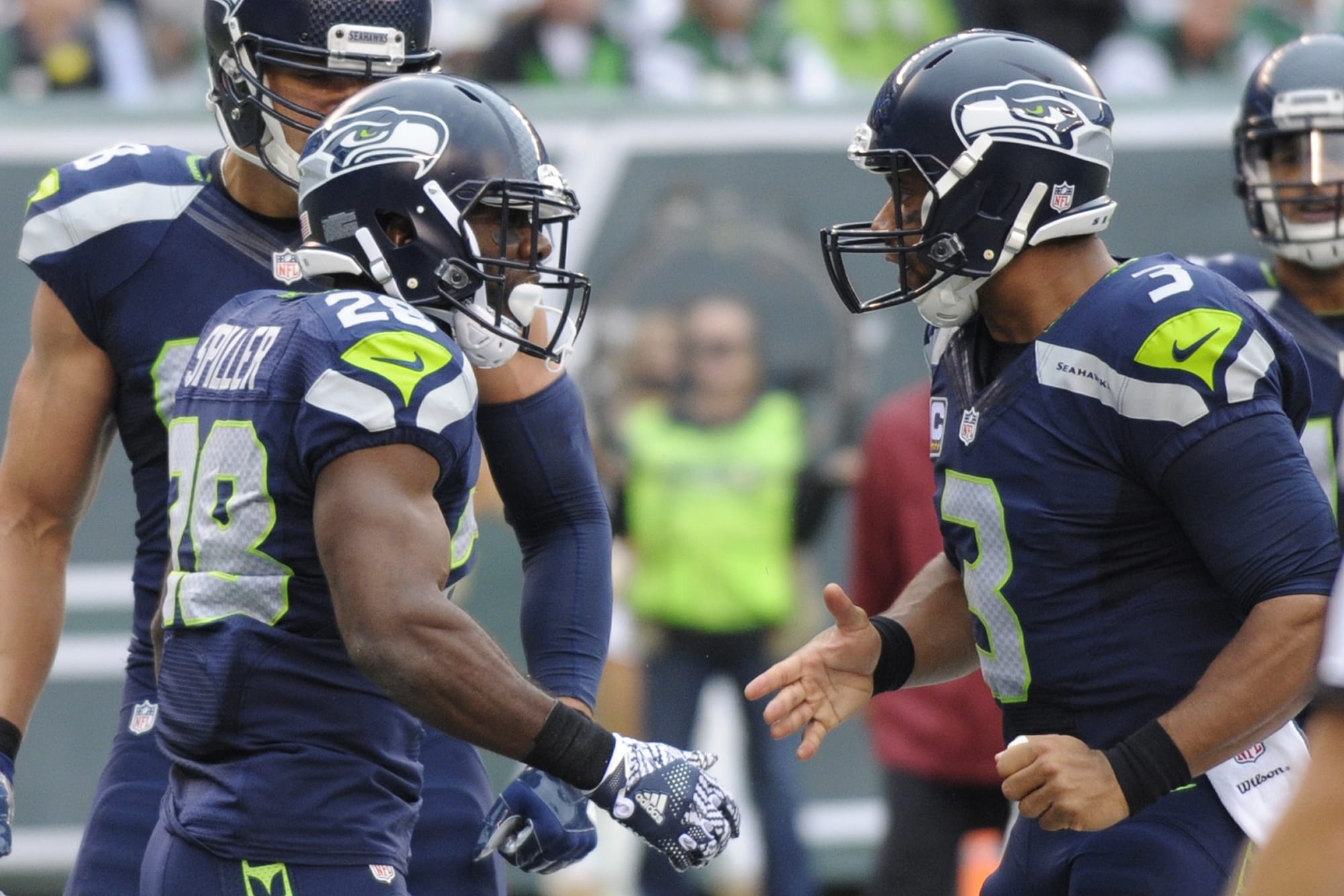 Seattle Seahawks quarterback Russell Wilson, right, celebrates with teammate C.J. Spiller, left, after they connected for a touchdown during the first half of an NFL football game against the New York Jets, Sunday, Oct. 2, 2016, in East Rutherford, N.J.