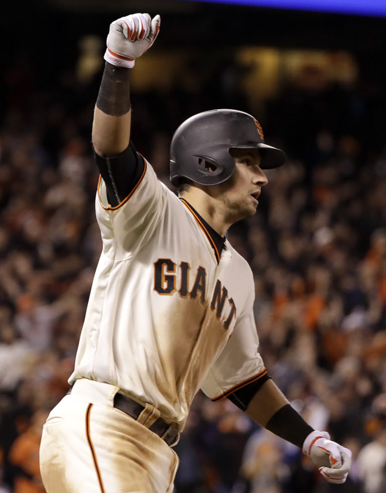 San Francisco Giants' Joe Panik celebrates after hitting a double to score Brandon Crawford against the Chicago Cubs during the thirteenth inning of Game 3 of baseball's National League Division Series in San Francisco, Monday, Oct. 10, 2016. The Giants won 6-5.