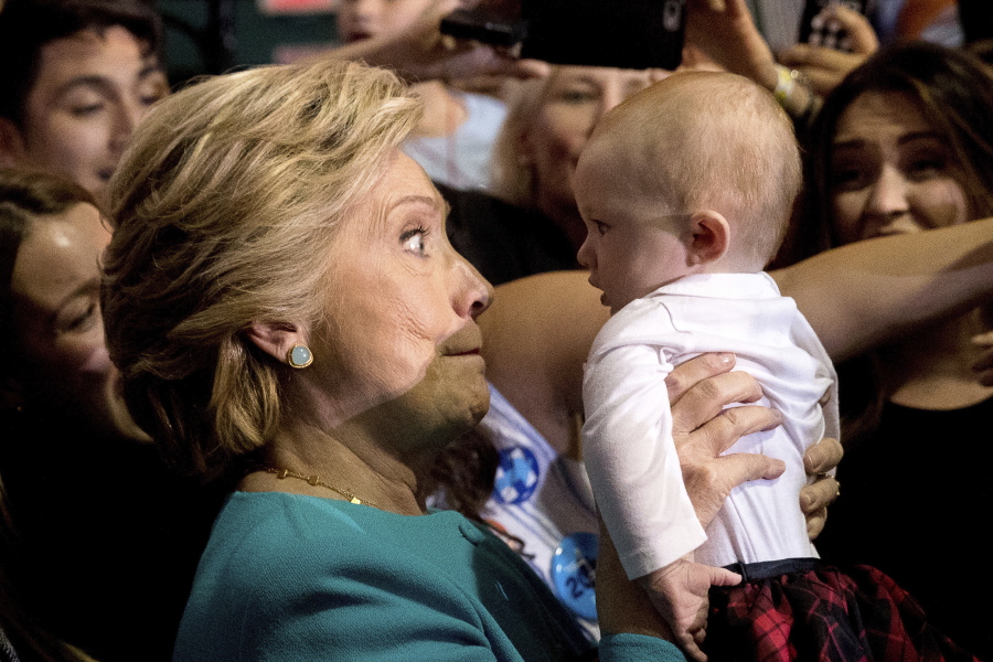 Democratic presidential candidate Hillary Clinton holds up a baby as she greets members of the audience after speaking at a rally at Palm Beach State College in Lake Worth, Fla., on Wednesday.