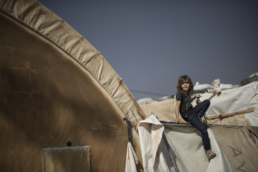 A girl plays outside her home in the Yahyawa camp for internally displaced Turkmen on the outskirts of Kirkuk, Iraq, Sunday, Oct. 30, 2016. Over 600 families from Tel Afar, a town west of Mosul, have been living in the camp for 2 years and are hoping for their town to be liberated from ISIS so they can return to their homes.