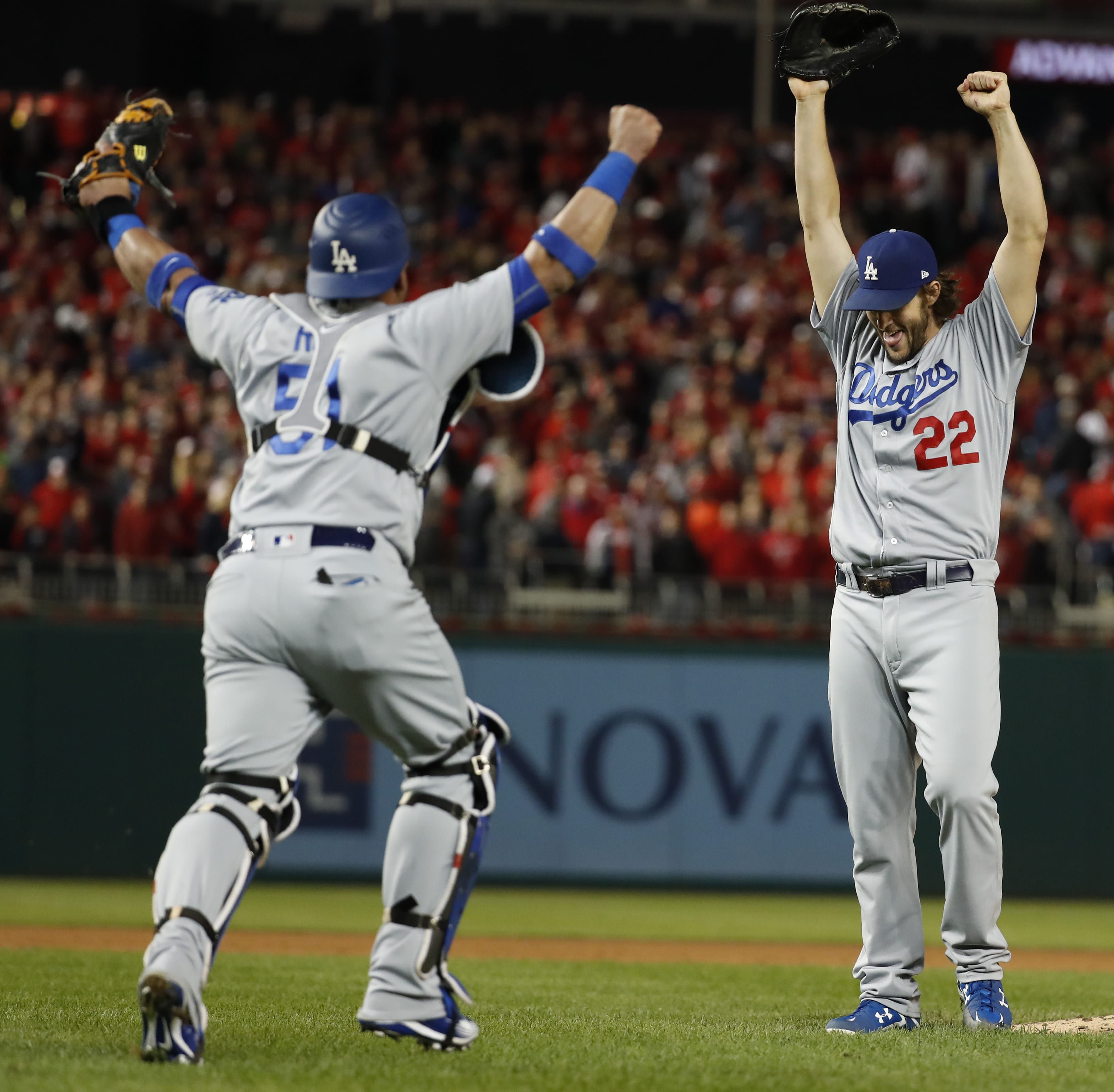 Los Angeles Dodgers pitcher Clayton Kershaw (22) and catcher Carlos Ruiz celebrate after Washington Nationals' Wilmer Difo struck out to end Game 5 of baseball's National League Division Series at Nationals Park early Friday, Oct. 14, 2016, in Washington. The Dodgers won 4-3.