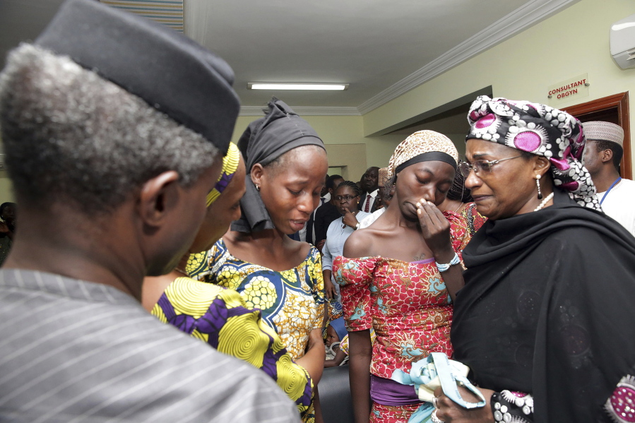 In this photo released by the Nigeria State House, Nigeria&#039;s Vice President Yemi Osinbajo, left, welcomes some of the freed Chibok school girls at the state House in Abuja, Nigeria, Thursday, Oct. 13, 2016. Twenty-one of the Chibok schoolgirls kidnapped by Boko Haram more than two years ago were freed Thursday in a swap for detained leaders of the Islamic extremist group ??? the first release since nearly 300 girls were taken captive in a case that provoked international outrage.