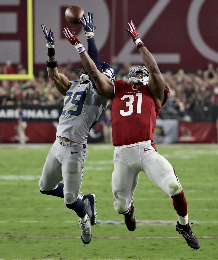 Seattle Seahawks free safety Earl Thomas (29) breaks up a pass intended for Arizona Cardinals running back David Johnson (31) during the first half of a football game, Sunday, Oct. 23, 2016, in Glendale, Ariz.