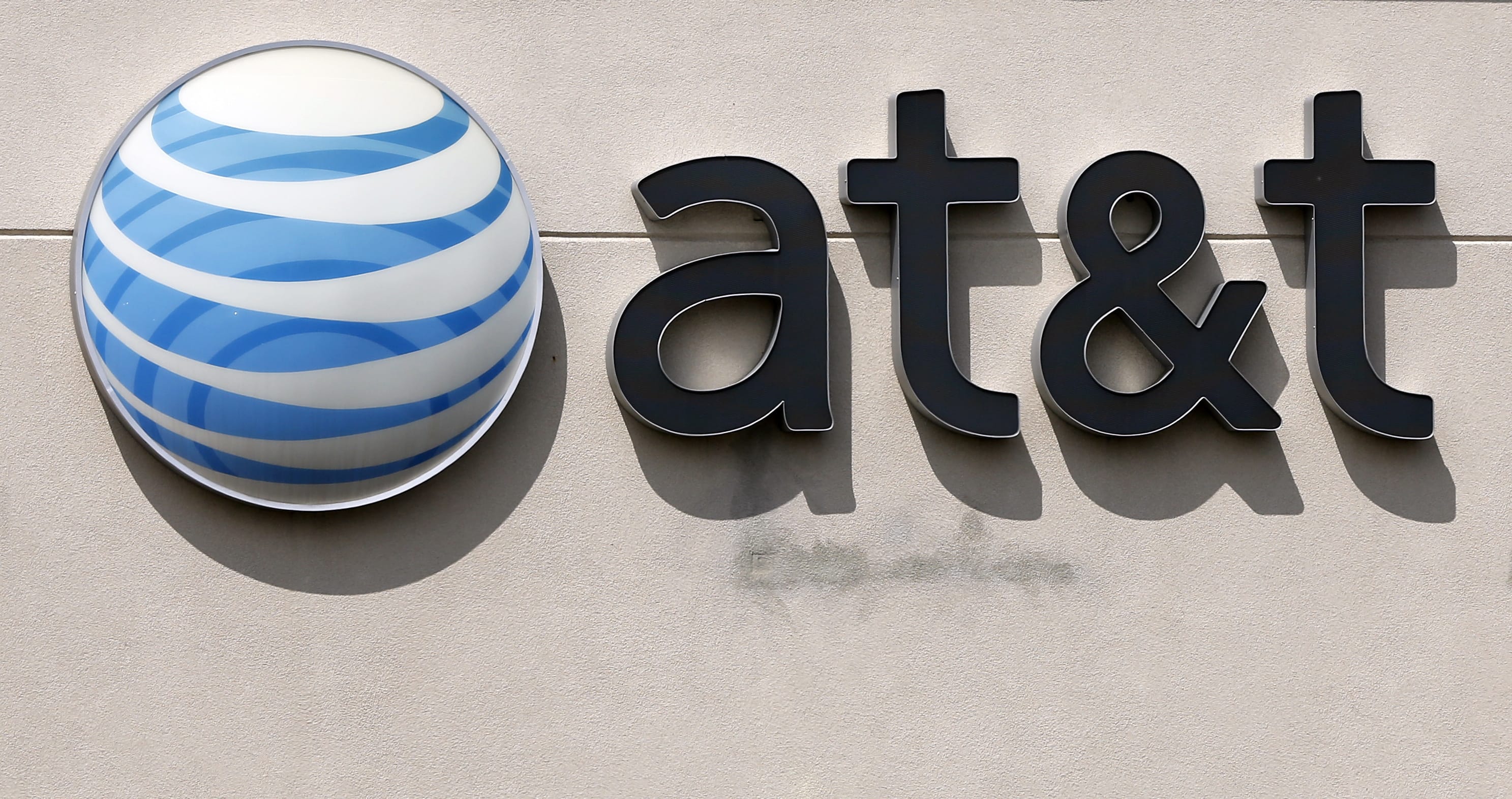FILE - This May 14, 2014 file photo shows an AT&amp;T logo on a store in Dedham, Mass. On Saturday, Oct. 22, 2016, several reports citing unnamed sources said the giant phone company is in advanced talks to buy Time Warner, owner of the Warner Bros. movie studio as well as HBO and CNN. AT&amp;T is said to be offering $80 billion or more, a massive deal that would shake up the media landscape.