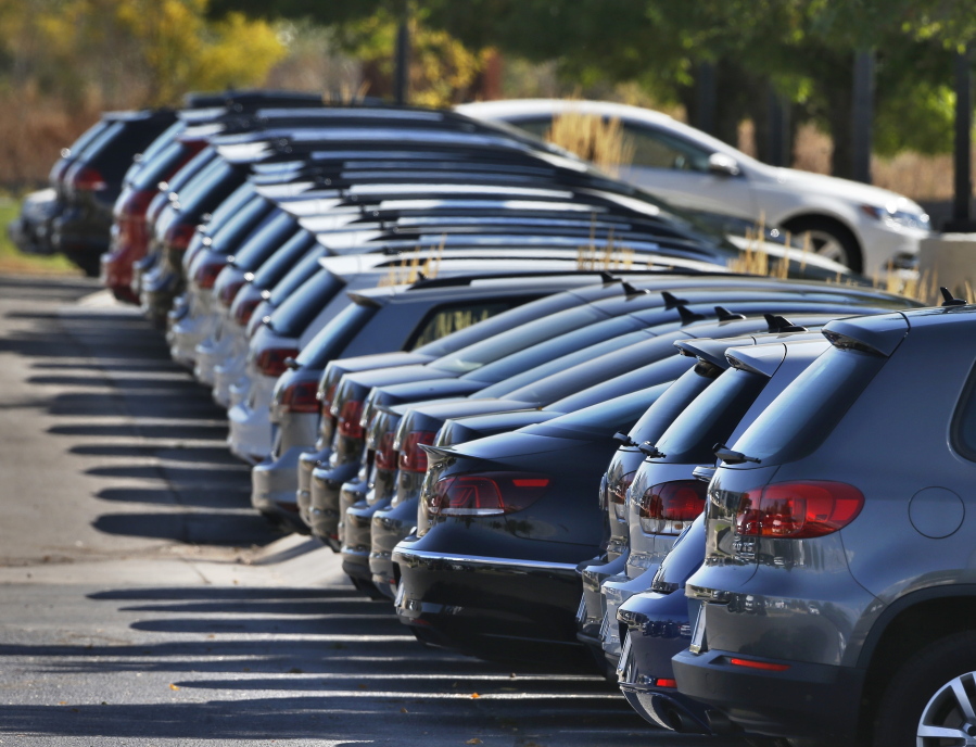 Volkswagens for sale are on display on the lot of a VW dealership in Boulder, Colo.