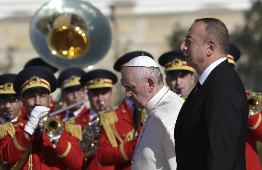 Pope Francis and Azerbaijan&#039;s President Ilham Aliyev, foreground right, review of the honor guard on the occasion of their meeting at the presidential palace Sunday in Baku, Azerbaijan. Francis traveled to Azerbaijan on Sunday for a 10-hour visit aimed at encouraging the country&#039;s inter-religious harmony while likely overlooking criticism of a referendum that extends the president&#039;s term and powers.