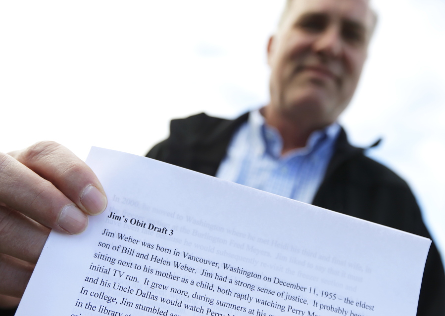 Jim Weber, of Tumwater, shows his third draft of his self-authored obituary, in Olympia. Weber, 60, said he began working on the document about a year ago. (Ted S.