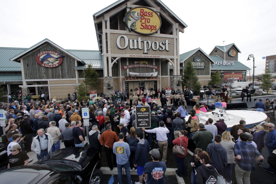 FILE - In this Wednesday, April 15, 2015, file photo, a large crowd of people line up as they wait for the grand opening of Bass Pro Shops Outpost store in Atlantic City, N.J. Outdoor gear giants Bass Pro and Cabela&#039;s will combine in a $4.5 billion deal announced Monday, Oct. 3, 2016.
