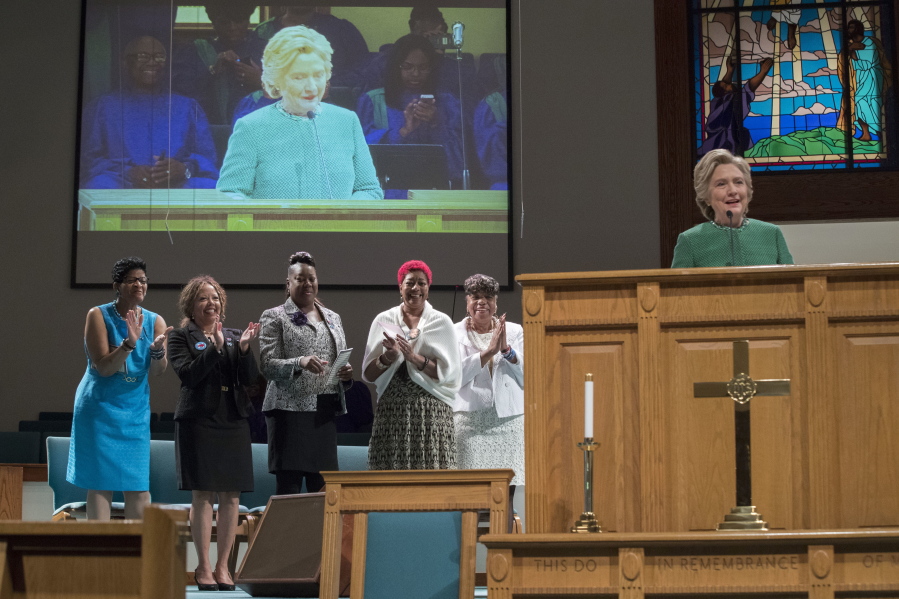 Democratic presidential candidate Hillary Clinton is joined by mothers of black men who died from gun violence, as she speaks during Sunday service at Union Baptist church in Durham, N.C.