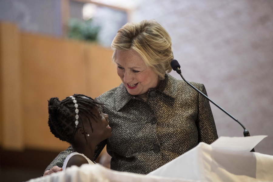 Democratic presidential candidate Hillary Clinton speaks with Zianna Oliphant onstage after speaking at the Little Rock AME Zion Church in Charlotte, N.C., Sunday, Oct. 2, 2016.