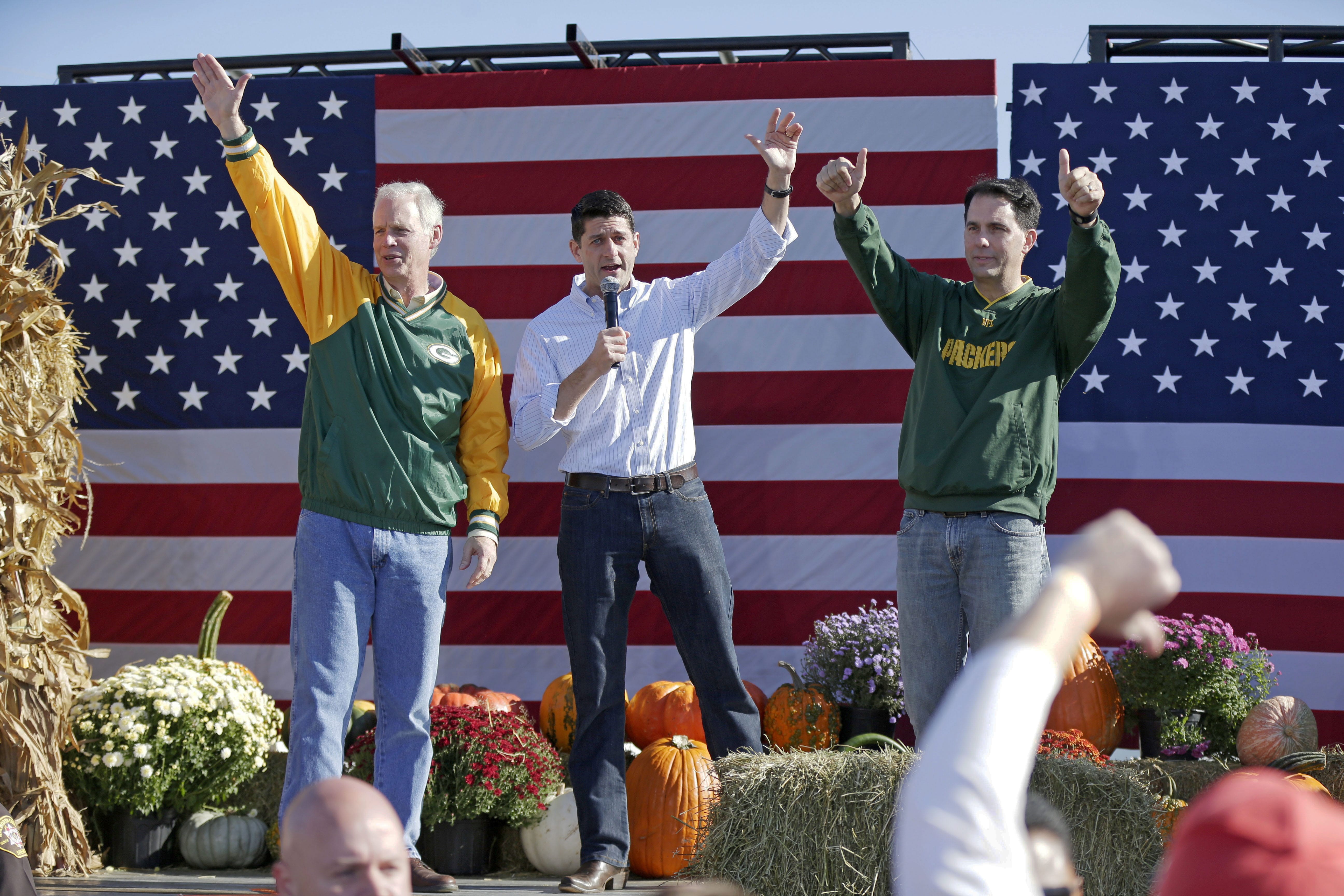 From left, U.S. Sen. Ron Johnson, House Speaker Paul Ryan and Gov. Scott Walker, acknowledge the crowd after they spoke at the "Fall Fest" Wisconsin Republican unity rally at the Walworth County Fairgrounds in Elkhorn, Wis. on Saturday, Oct. 8, 2016.