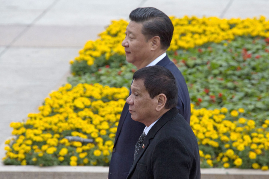 Philippine President Rodrigo Duterte, front, walks with Chinese President Xi Jinping during a welcome ceremony outside the Great Hall of the People in Beijing, China, Thursday, Oct. 20, 2016.