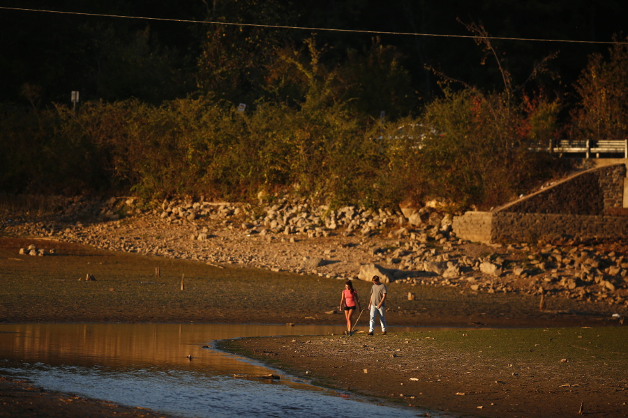 A couple walks near Lake Purdy where water levels have dropped several feet due to a sever drought, in Birmingham, Ala. Hotter than normal temperatures combined with the below normal rainfall have worsened drought conditions across Alabama. The very worst drought conditions are in the mountains of northern Alabama and Georgia.