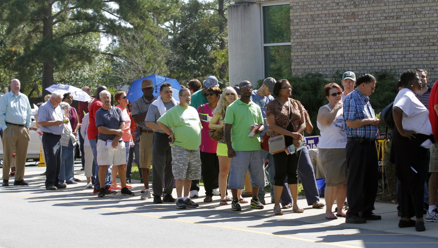 The line wraps around the corner of the building as hundreds of voters came out on the first day of early voting at the Hope Mills Recreation Center in Hope Mills, N.C., on Thursday.  The town is still recovering from the effects of Hurricane Matthew, which came through the area a few weeks ago.