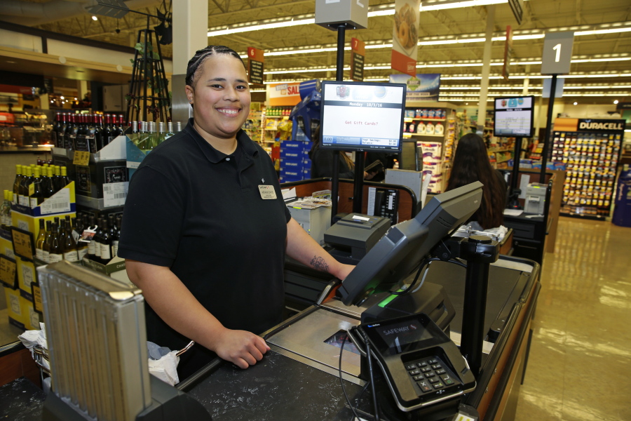 Safeway worker Ariana Davis of Renton is the sponsor of Initiative 1433, which would raise the state minimum wage. (ted s.