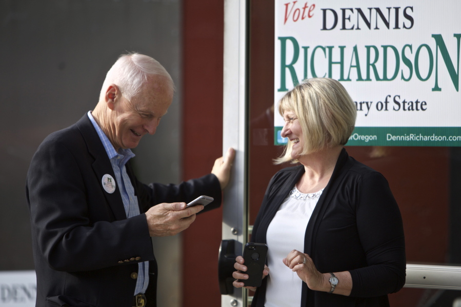 FILE--In this May 17, 2016, file photo, Oregon Republican Secretary of State candidate Dennis Richardson, left, and his wife Cathy Richardson take a phone call during a primary election night gathering for supporters in Portland, Ore. With a Republican threatening to take a state-wide office for the first time in many years in Oregon, the battle for secretary of state has become the hottest state race.