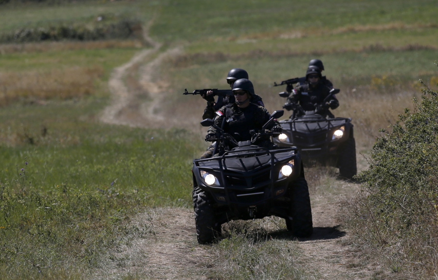 Serbian officers patrol near the border between Serbia and Bulgaria, not far from the border crossing Vrska Cuka, about 250 kilometers (155 miles) southeast of Belgrade, Serbia.