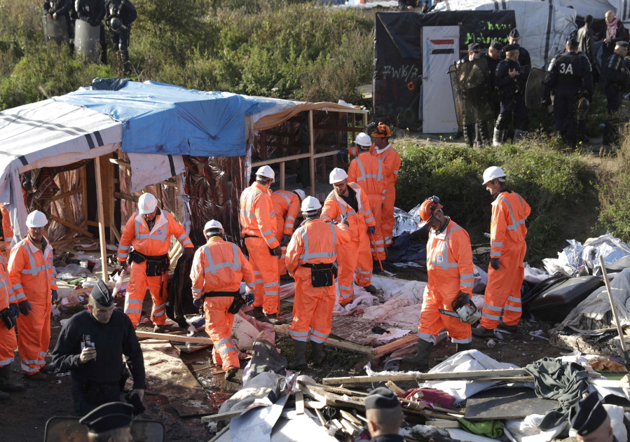 Crews demolish shelters in the migrant camp known as &quot;the jungle&quot; Tuesday near Calais, France.