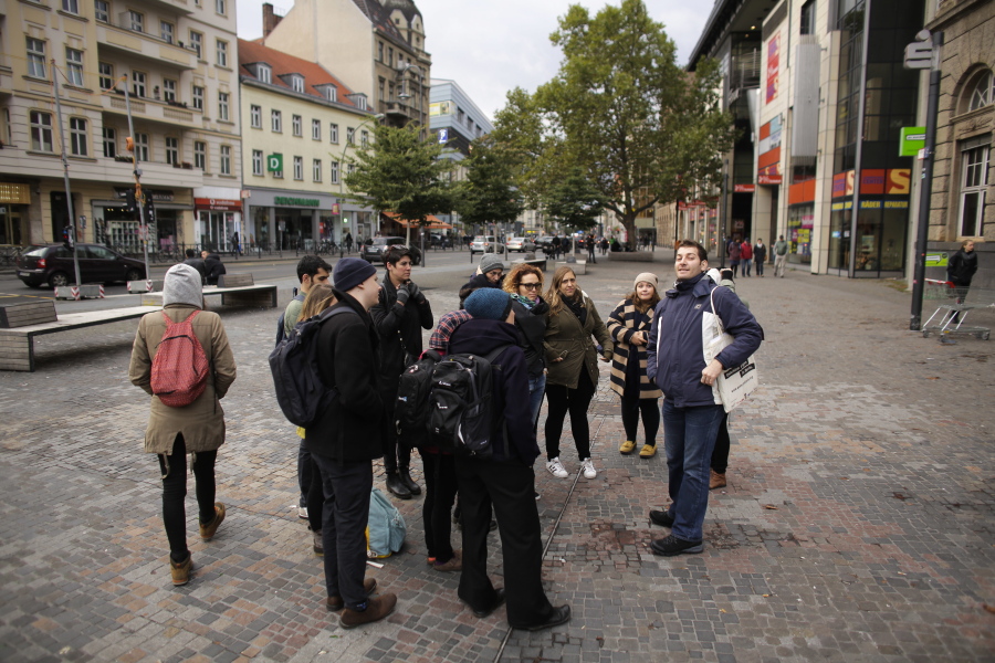 Refugee Firas Zakri from Syria, right, a tour guide of the so-called &#039;Refugee Tours&#039;  talks to a group of people during a tour through the district of Neukoelln in Berlin, Germany.