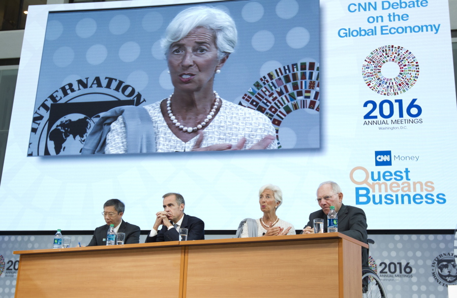 International Monetary Fund Managing Director Christine Lagarde, second from right, accompanied by, from left, Deputy Governor of the People&#039;s Bank of China Yi Gang, Bank of England Gov. Mark Carney, and German Finance Minister Wolfgang Schauble, speaks Thursday at the CNN Debate on the Global Economy at IMF headquarters in Washington.