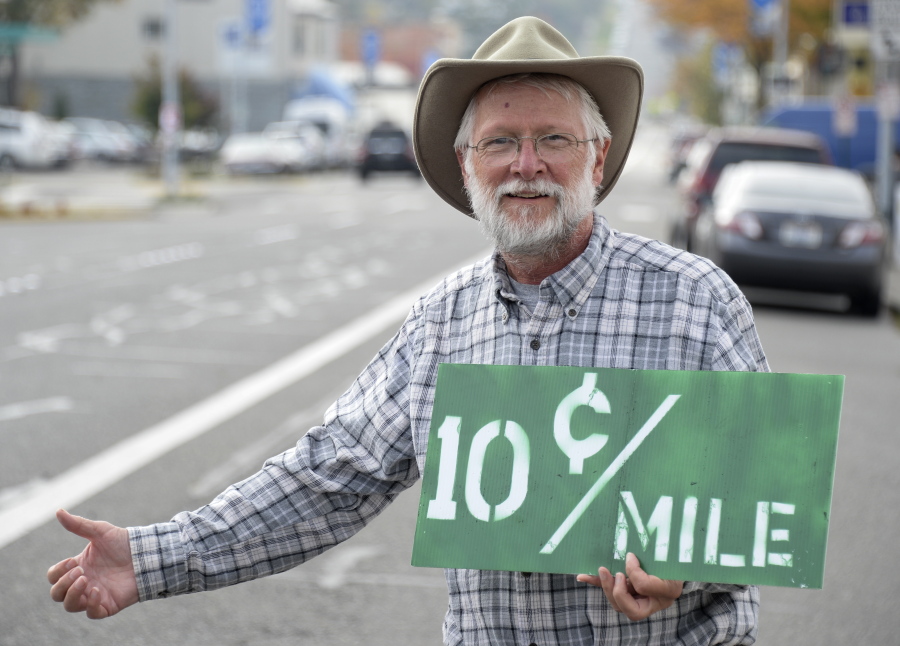 In this Thursday, Sept. 29, 2016 photo, Michael Schneider, a Lummi Island resident who hitchhikes all over the country with a pay-as-he-rides offer to drivers, poses in Bellingham, Wash. (Philip A.