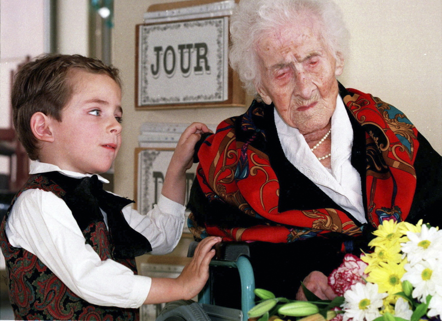 Thomas, 5, looks at Jeanne Calment after he brought her flowers at her retirement home Feb. 12, 1997 in Arles, southern France. Calment, believed to be the world&#039;s oldest person, died at the age of 122 in 1997.