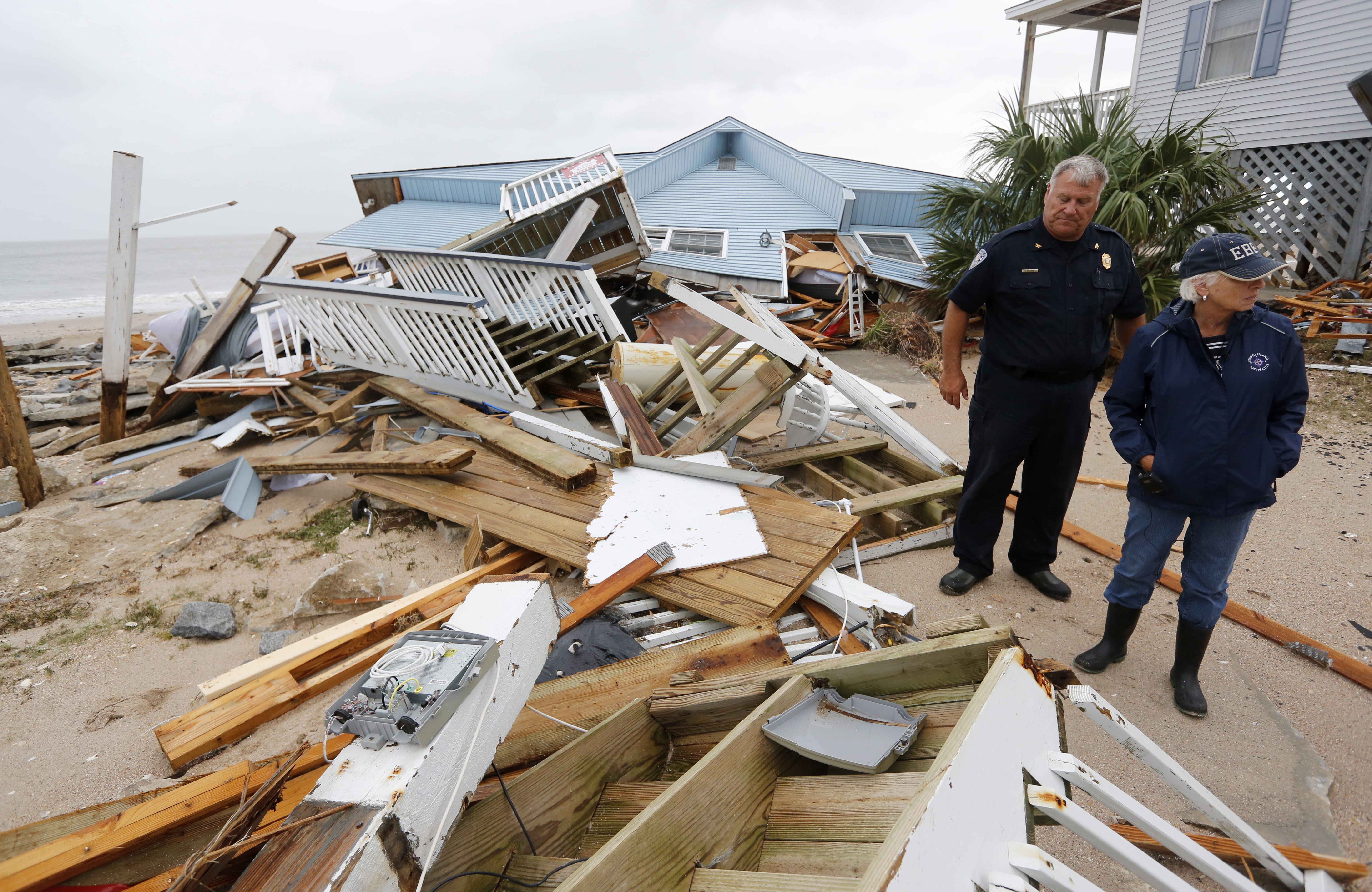 Town of Edisto Beach Chief of Police George Brothers, left, and Mayor Jane Darby survey the damage done to homes along Palmetto Blvd after Hurricane Matthew slammed into their tiny beach community Saturday, October, 8, 2016. The four-lane boulevard has been covered with sand.