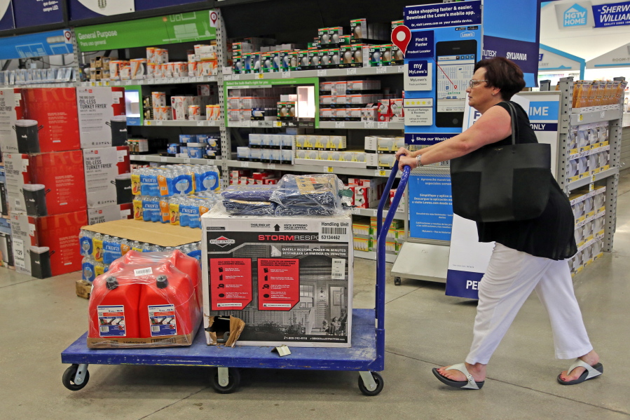 Kerri Vittimberga of Wilton Manors, Fla., buys a generator, tarps and gas cans Tuesday at Lowe&#039;s in Oakland Park, Fla. Vittimberga, originally from Boston, says this is her &quot;first big storm&quot; in the two years she has lived in Florida.