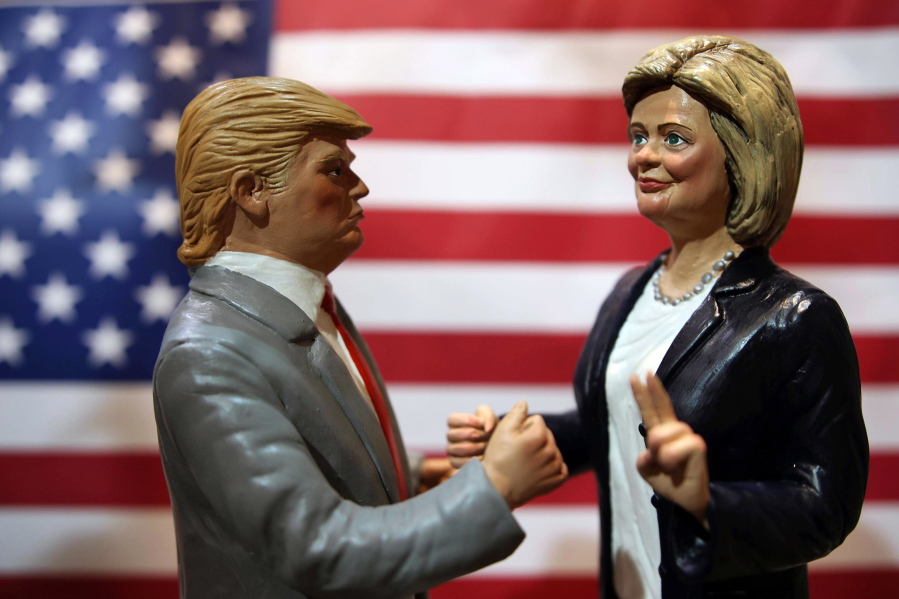 Statuettes depicting the presidential candidates Donald Trump, left, and Hillary Clinton are displayed in a shop in Via San Gregorio Armeno, the street of nativity scene craftsmen, in Naples, Italy, on Tuesday. On Nov. 8, Americans will vote for their next president.