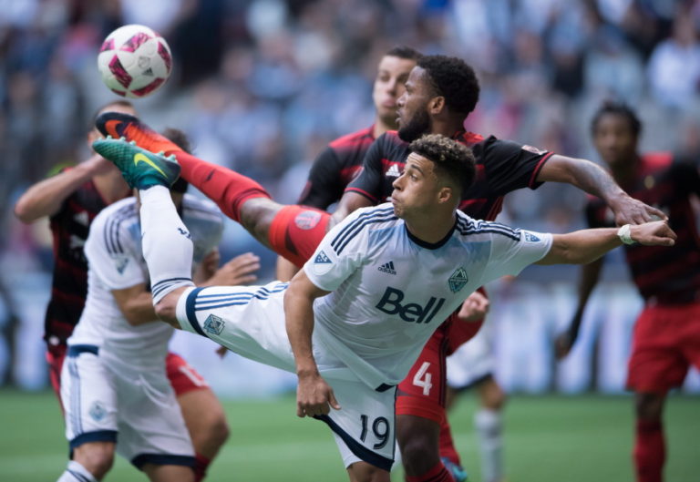 Vancouver Whitecaps&#039; Erik Hurtado, front, and Portland Timbers&#039; Jermaine Taylor reach for the ball with their feet during the first half of an MLS soccer game in Vancouver, British Columbia, on Sunday Oct. 23, 2016.