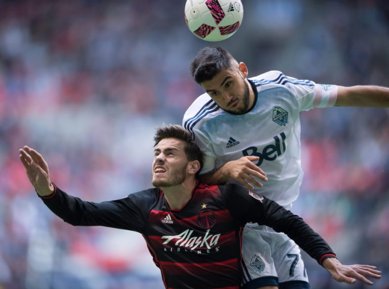Portland Timbers&#039; Lucas Melano, left, and Vancouver Whitecaps&#039; Pedro Morales vie for the ball during the first half of an MLS soccer game in Vancouver, British Columbia, on Sunday Oct. 23, 2016.