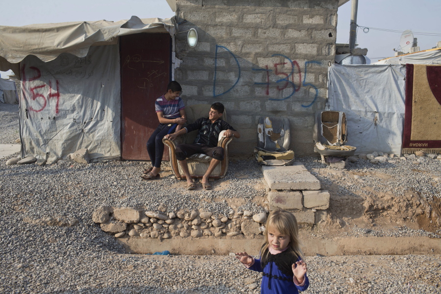 Children converse inside the Baharka camp for displaced persons on the outskirts of Irbil, Iraq, on Tuesday. Nearby Mosul, the largest city controlled by the Islamic State group, is still home to more than 1 million civilians.