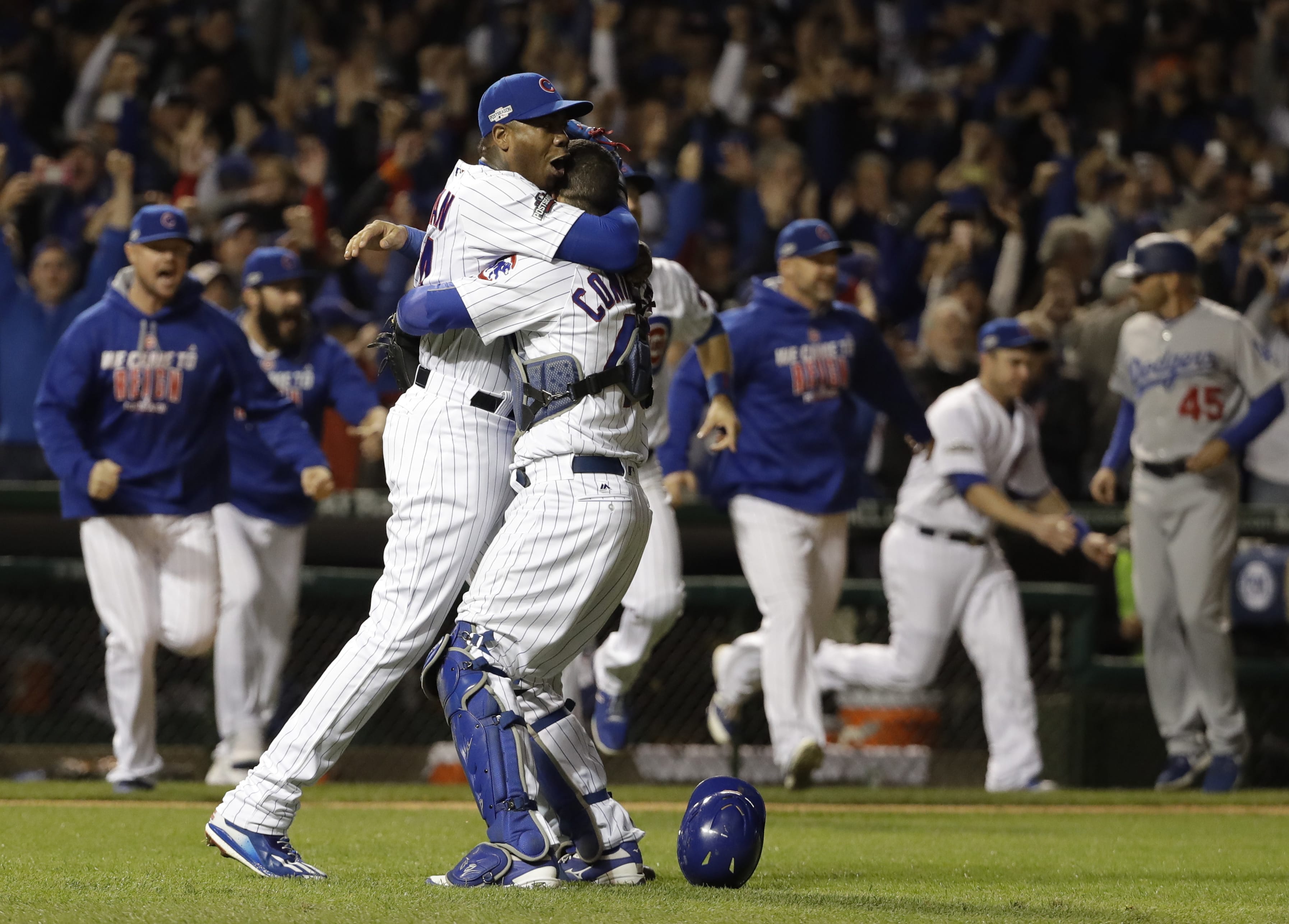 Chicago Cubs catcher Willson Contreras and relief pitcher Aroldis Chapman (54) celebrate after Game 6 of the National League baseball championship series against the Los Angeles Dodgers Saturday, Oct. 22, 2016, in Chicago. The Cubs won 5-0 to win the series and advance to the World Series against the Cleveland Indians. (AP Photo/David J.