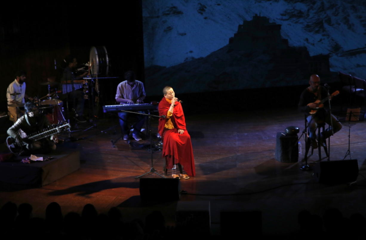 Buddhist nun and musician Ani Choying Drolma, center, performs during a concert in Mumbai, India.