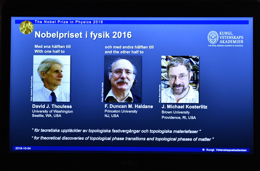 A overhead projector displays the photos of the winners of the Nobel Prize in physics, at the Royal Swedish Academy of Sciences, in Stockholm, Sweden, on Tuesday. David Thouless, Duncan Haldane and Michael Kosterlitz have won the Nobel physics prize. Nobel jury praises physics winners for &#039;discoveries of topological phase transitions and topological phases of matter&#039;.