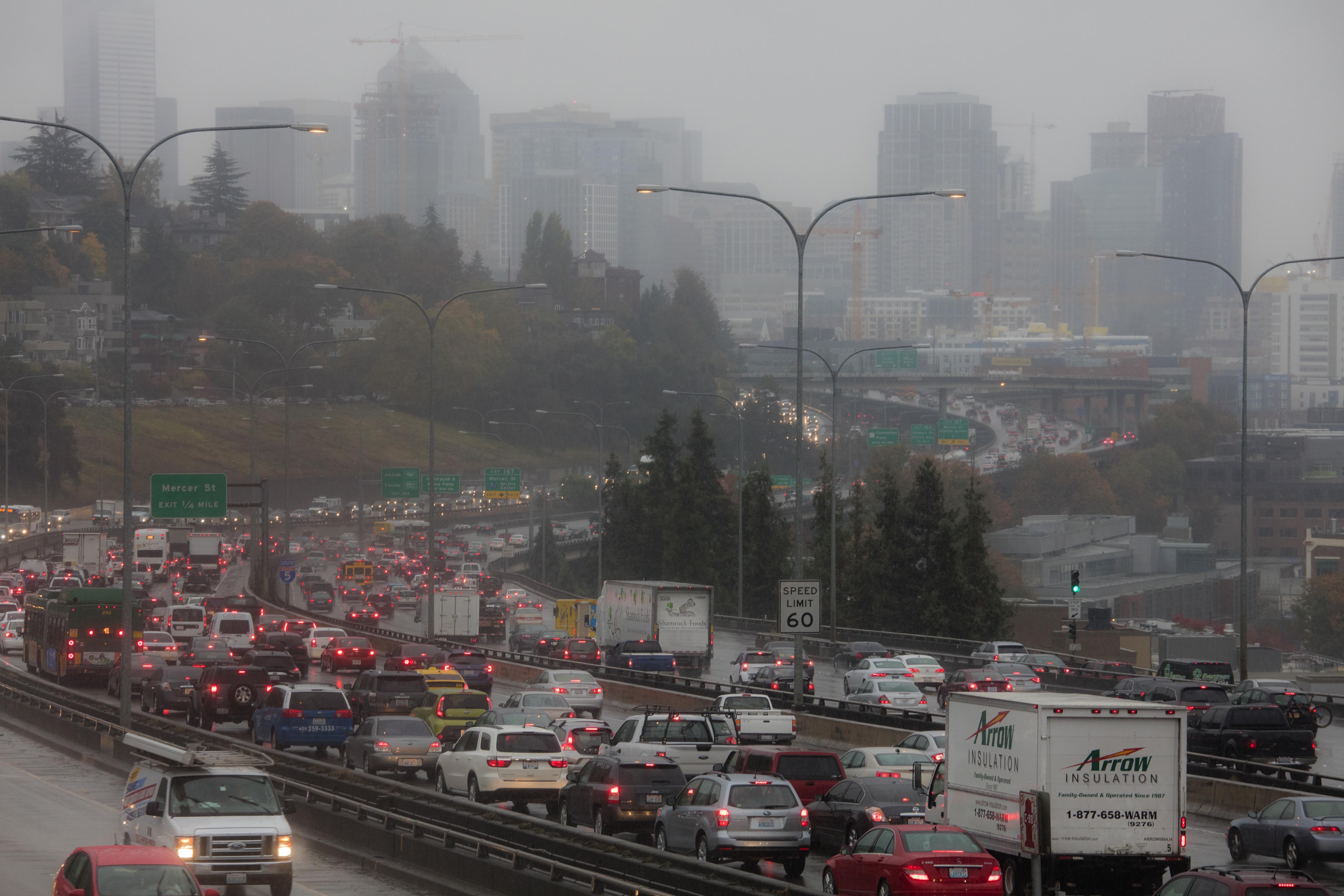 Traffic moves slowly, as drivers worked their way through the morning rainstorm, Thursday, Oct. 13, 2016 in Seattle. The moderate-to-heavy rains Thursday kick off a stormy period - with a lull predicted Friday before the weather intensifies again Saturday.