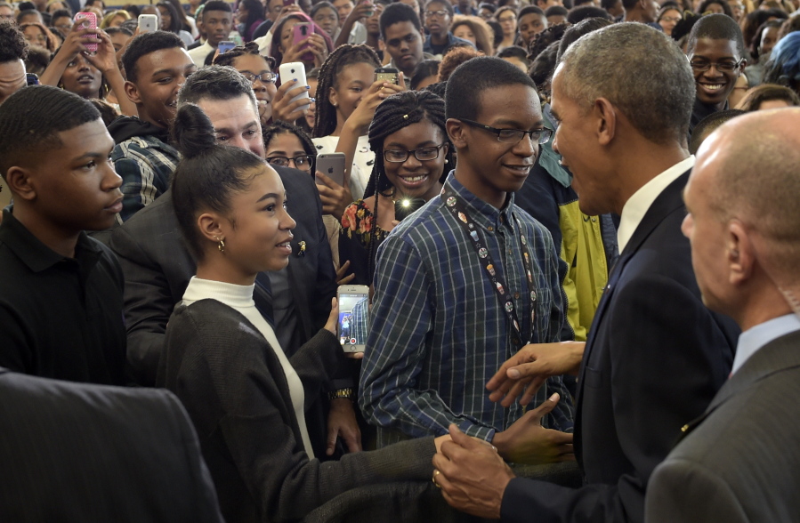 President Barack Obama greets students after speaking at Benjamin Banneker Academic High School in Washington on Monday where he highlighted the steady increase in graduation rates.