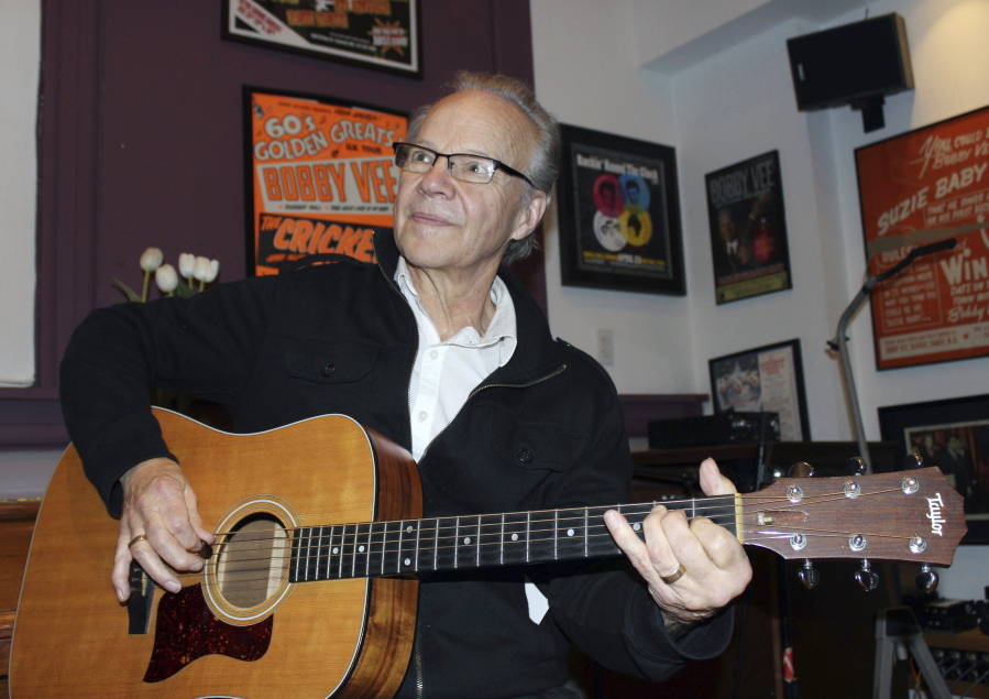 Bobby Vee plays the guitar at his family&#039;s Rockhouse Productions in St. Joseph, Minn., in 2013. Vee, whose rise toward stardom began as a 15-year-old fill-in for Buddy Holly after Holly was killed in a plane crash, died Monday of complications from Alzheimer&#039;s disease. He was 73.